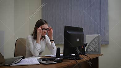Tired businesswoman under a lot of stress using computer