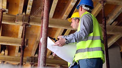 Engineer or architect discussing construction issues with colleague