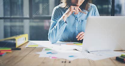 Young architect work project. Photo woman working with new startup project in modern loft. Generic design notebook on