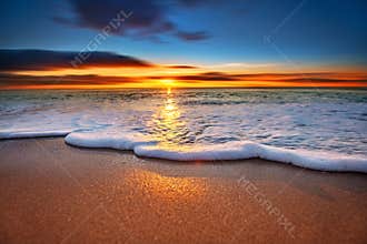 Sunrise light shining on ocean.