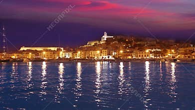Ibiza Eivissa town sunset with city lights reflection in Mediterranean sea of balearic Islands