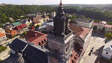 Aerial view over cathedral on countryside in mountains at sunset