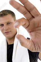 Young man showing pill
