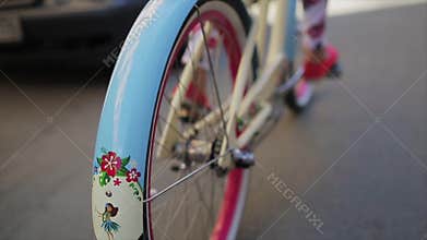 Back side of girl cycling in summer day wheel of a bicycle focus in. Slow motion