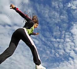 Girl running under blue sky