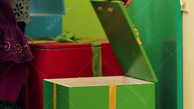 Close up kids opening the box with toys in kindergarten