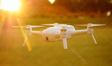 Mini Camera Drone Flying at Sunset
