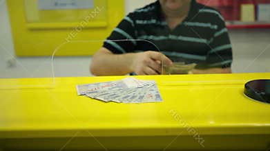 Close up on man in bank counting money
