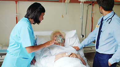 Female doctor putting oxygen mask on patient