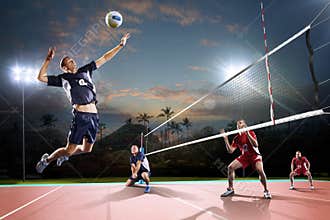 Professional volleyball players in action on the night court