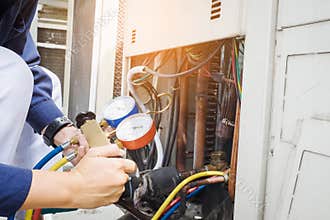 Technician checking air conditioner