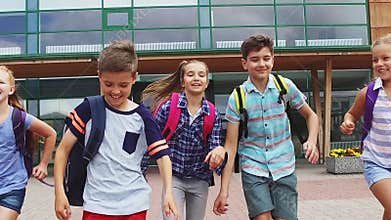 Group of happy elementary school students running