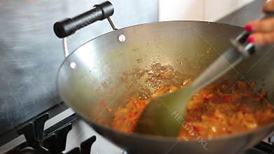 Making a curry in a wok.