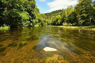 Beautiful summer landscape with river, forest, sun and blue skies. Natural background.