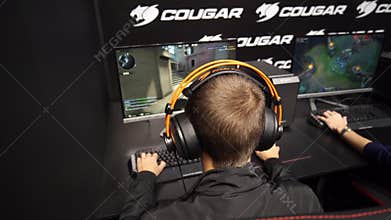 Teenagers playing video games on computers.