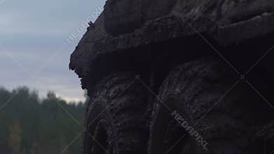 Military armored personnel carrier travels along the muddy road. Dirty armored vehicle
