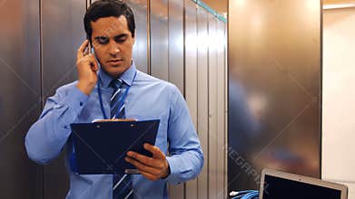 Technician talking on mobile phone