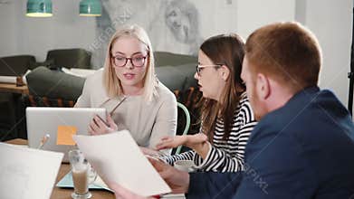 Business start-up meeting in a modern office architectural sketch planning. happy young people involved in conversation