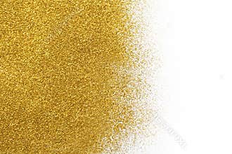 Golden glitter sand texture on white, abstract background.