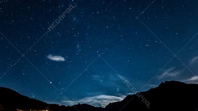 Timelapse stars and moon over mountain night sky. Moonrise