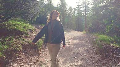 Woman hiker walking around the Braies lake and enjoys his spectacular sceneries, Dolomites, Italy