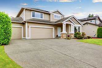 Neat beige home with two garage spaces.
