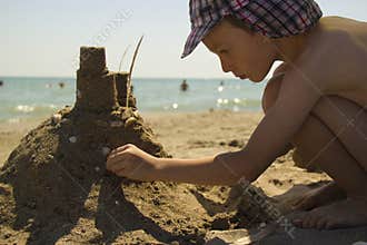 Boy making sand castle at beach