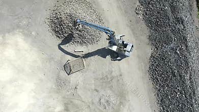 Iron raw materials recycling pile, work machines. Metal waste junkyard. Excavators diggers works on a garbage dump .View from