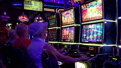 Motion of people playing slot machine