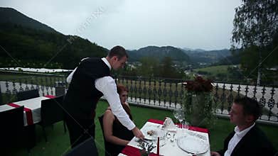 waiter served dinner to lovely couple on date