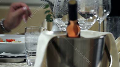 young and woman in black low cut dress who is sitting and waiting for the