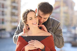 Man putting a blank jewel to his girlfriend