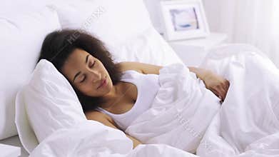 African woman sleeping in bed at home bedroom