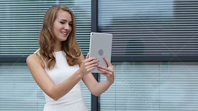 Online Video Chat on Tablet by Beautiful Girl, Outside Office