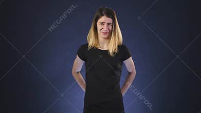 Disgusting emotion. girl on dark background