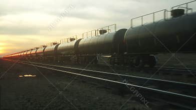 Freight train oil tankers. Against Sunrise. Realistic cinematic 4k animation.