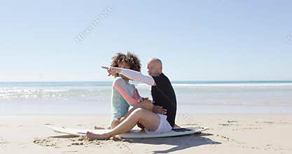 A couple embracing on a surfboard