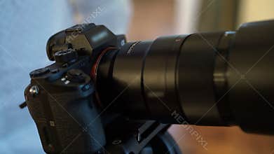 Man working with mirrorless camera on tripod
