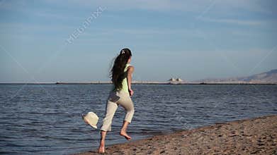 Young girl running away at the beach in Egypt resort, slow motio