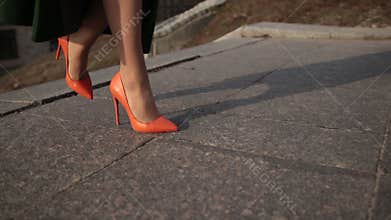 female legs in high heels climbing up stairs