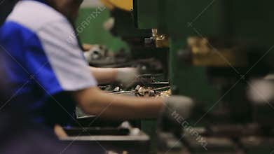 People work in a factory. Manual assembly of parts in the enterprise