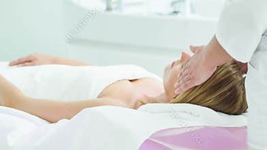 Serine young woman getting head massage