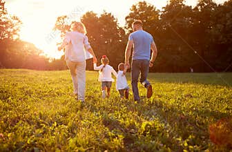 Family in nature together, back view