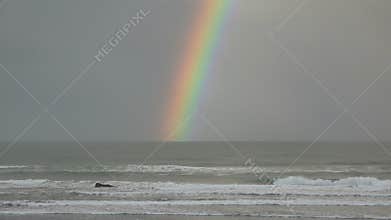 Static very wide shot of a rainbow over the pacific ocean oregon united states