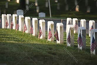 Grave markers with flags at Arlington National Cemetery on Memorial Day