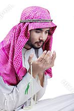 Muslim man prays to the Allah on studio