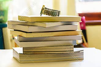 Watch placed on the books on the table