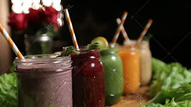 Jars of various smoothies with straws for dieting