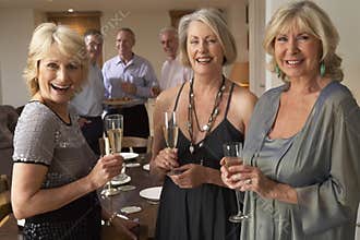 Women Enjoying Champagne At A Dinner Party