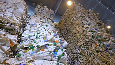 Plastic bottles ready for recycling. Garbage sorting plant. Dolly shot.